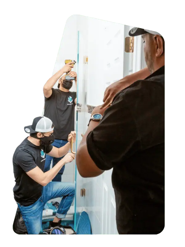 men installing frameless glass door.