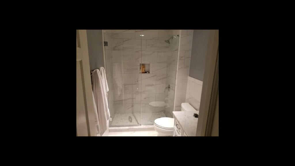 shower with frameless glass doors.