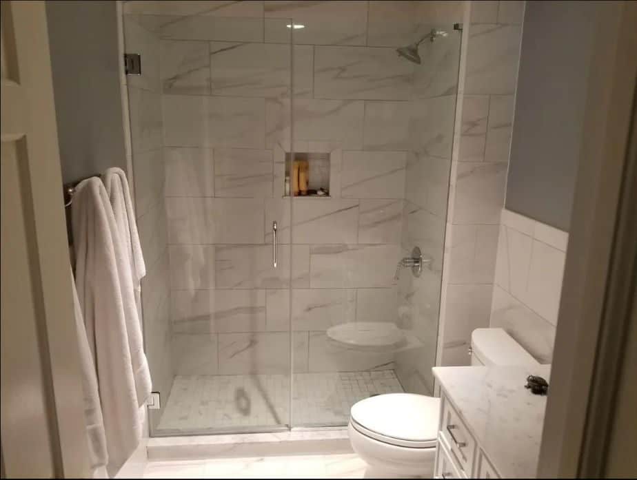 shower with frameless glass doors.