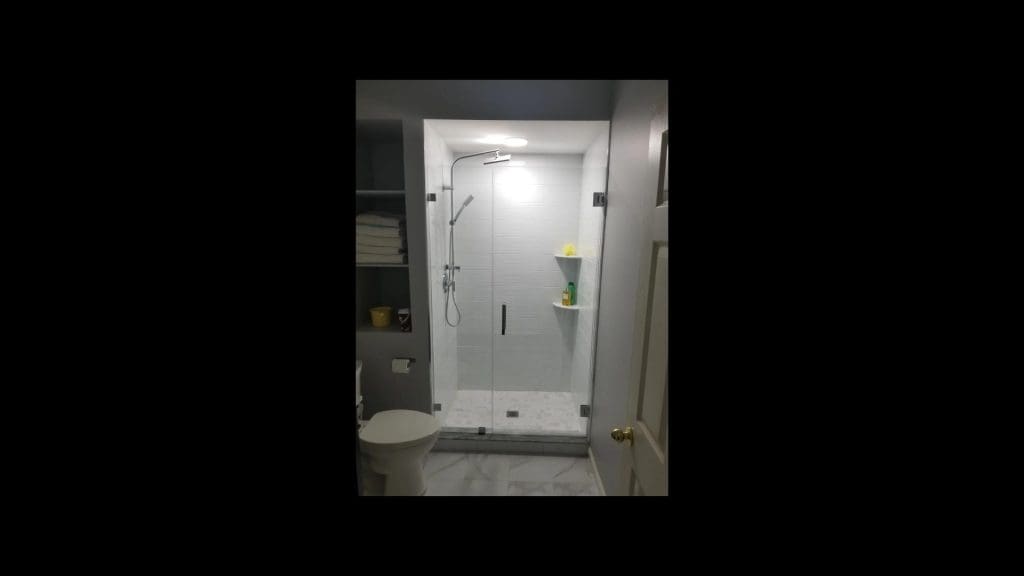shower with frameless glass door.