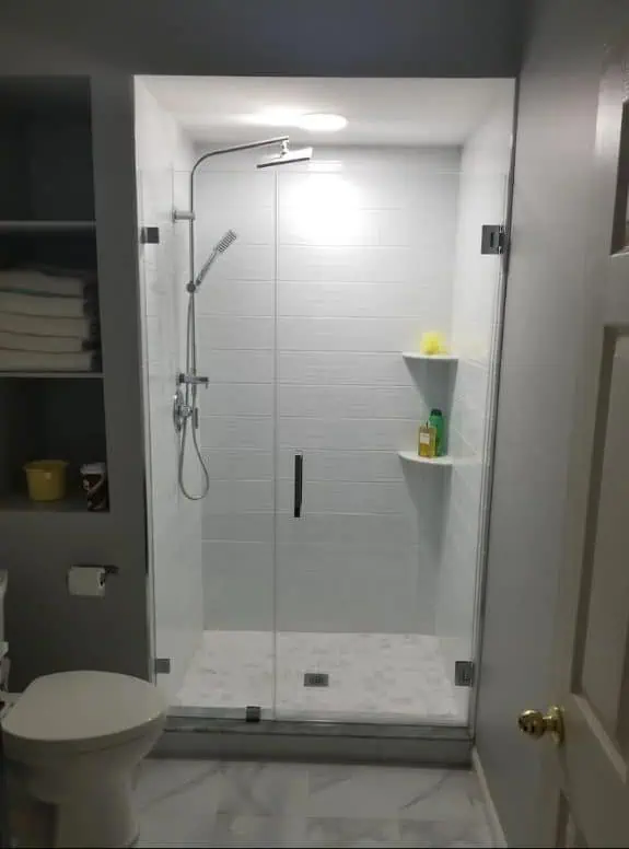 shower with frameless glass door.